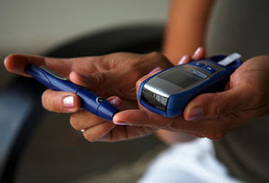 A woman checking her blood sugar