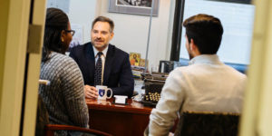 Paul Glader talking to students in his office