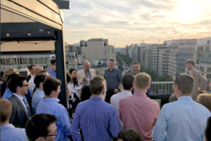 Jospeh Loconte giving a talk on a rooftop during a Providence Magazine happy hour
