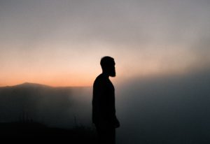Man in silhouette with fog