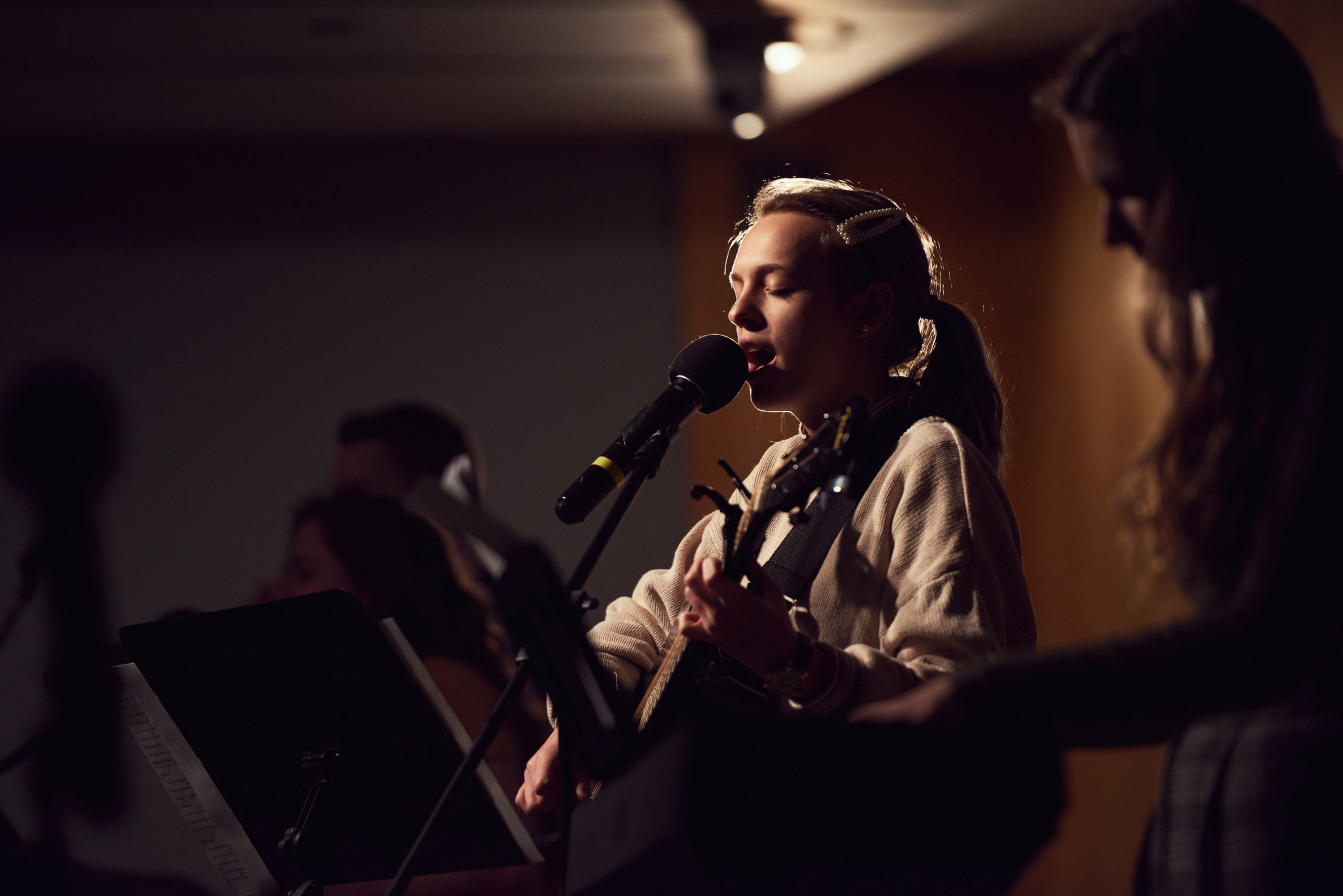 woman lead worship at refuge