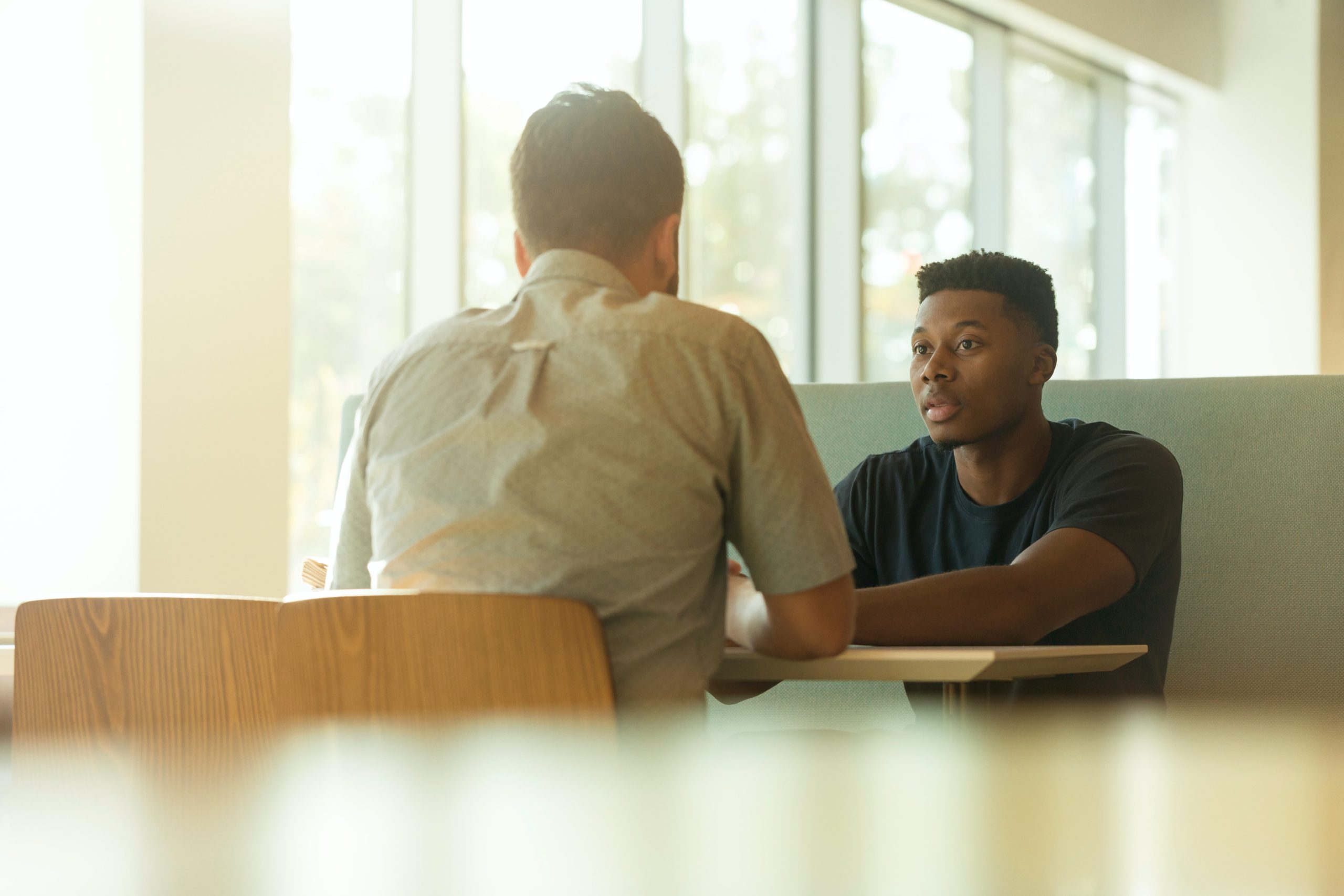 men at a table having an entrance interview